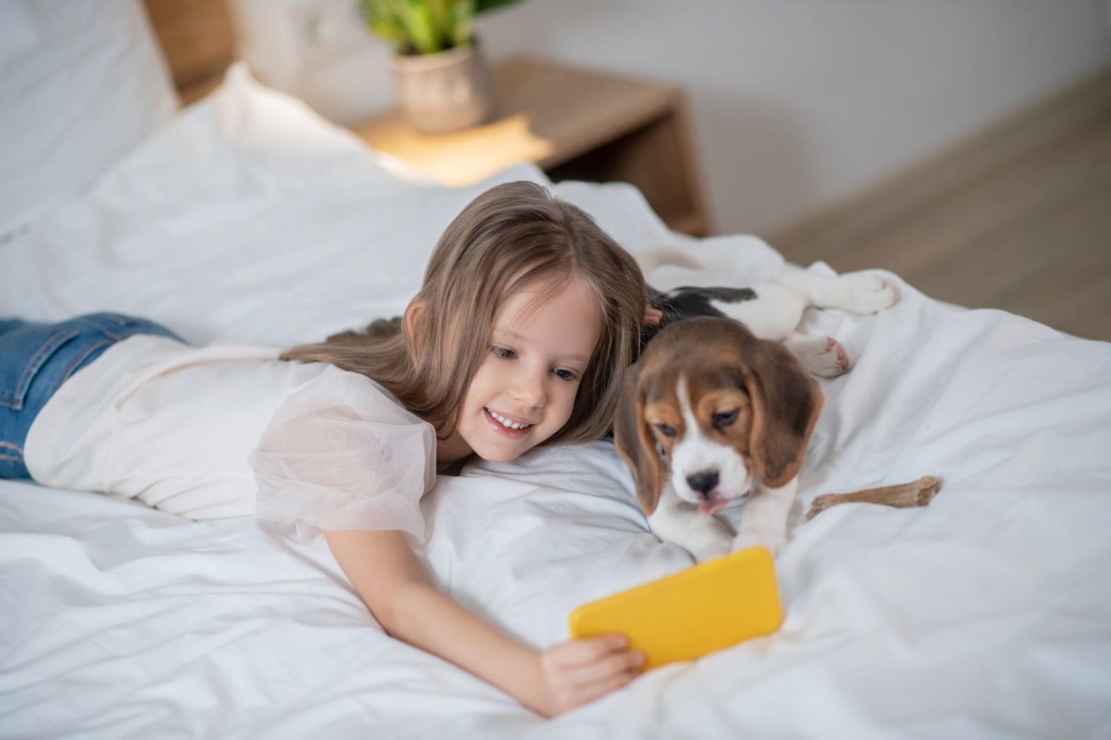 child-taking-selfies-with-her-dog