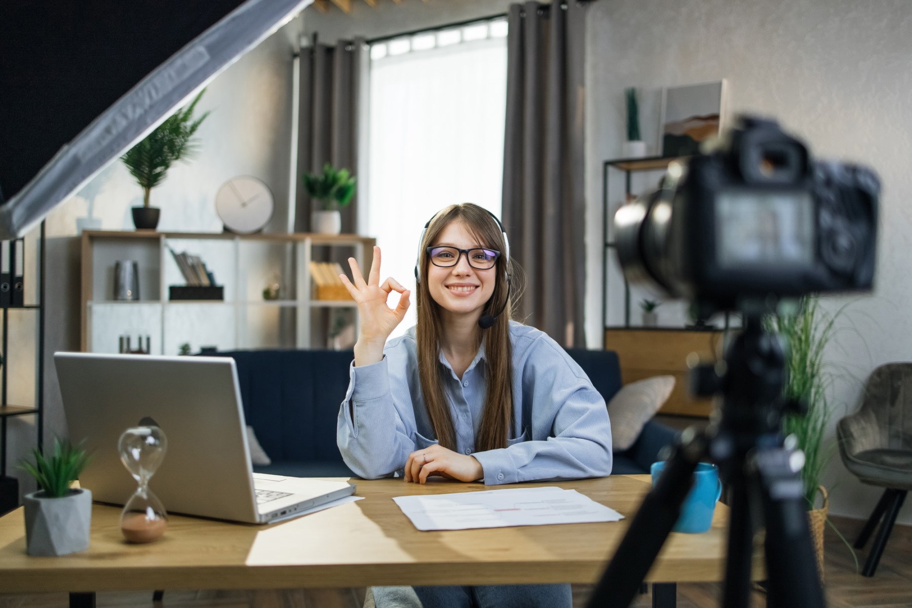 happy_female_speaker_talking_showing_sign_ok_on_ca_2022_01_31_05